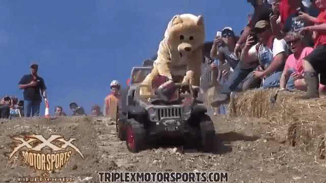 men-and-women-engage-in-dangerous-downhill-racing-in-plastic-toy-cars.gif