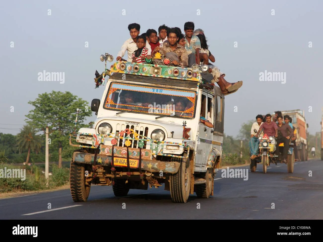 Jeep Wrangler JL Is Gladiator a Jeep? overloaded-indian-jeep-taxi-traveling-down-bengali-highway-at-sunset-CY08WA